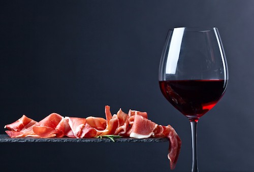 Drinking wine with cured ham is a popular activity in Madrid. Expect to be offered either a glass of Rioja or Ribera when quickly hopping from restaurant to restaurant.