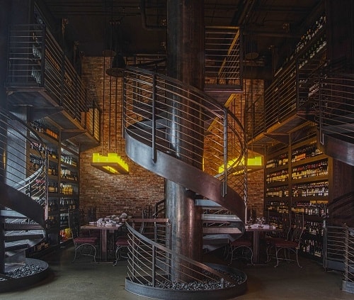 The stunning spiral staircase and wine wall within Purple Café and Wine Bar in Bellevue. Image courtesy Visit Bellevue.