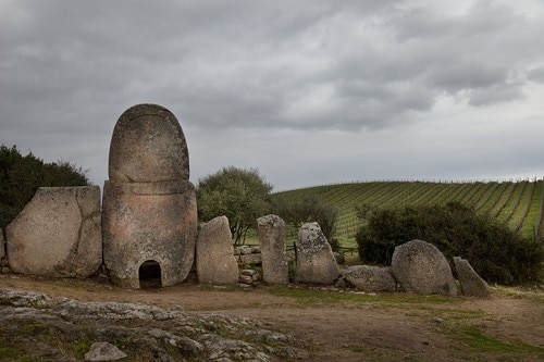 A Bronze-age Burial site located alongside vineyards in Sardinia. "Giants' tombs"