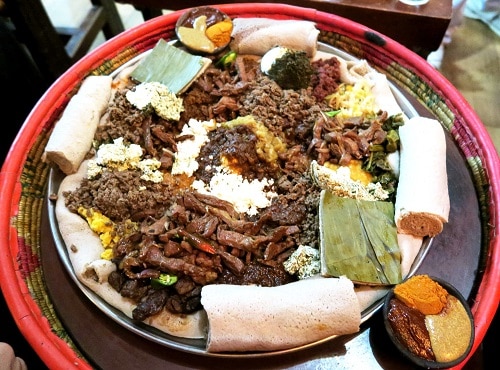 Injera topped with an assortment of wots and meats at Yod Abyssinia,  Addis Ababa (Photo by Cheryl Tiu)