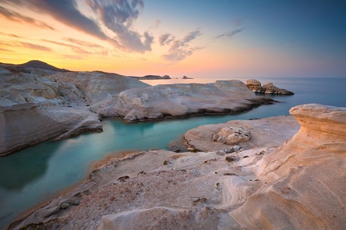 Ancient volcanic rock formations dot the island of Milos.