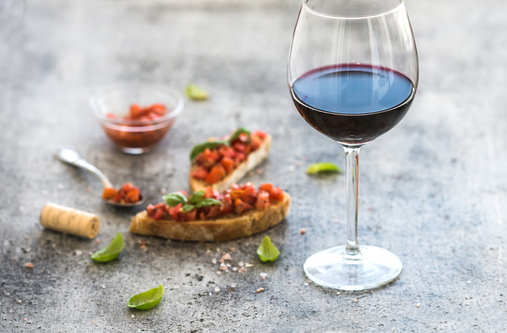 Glass of vegan wine paired with food on the table