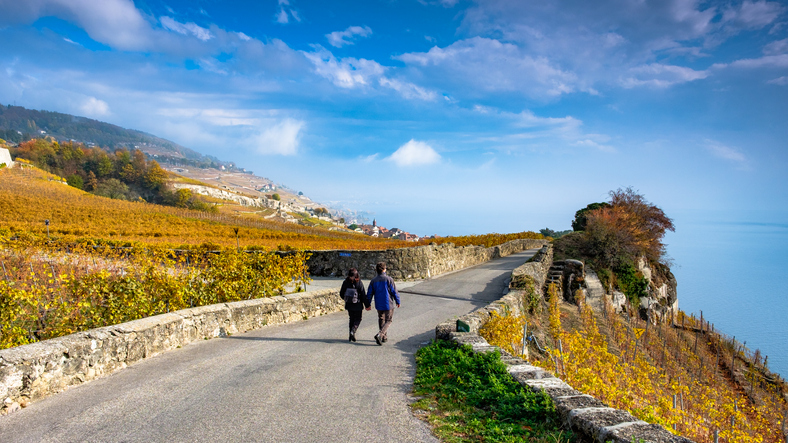 Young couple walking between wineries in Lavaux