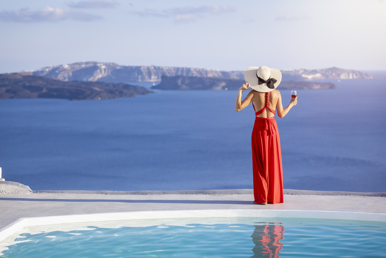 Greece Itinerary, woman looking out from Santorini with a beautiful view