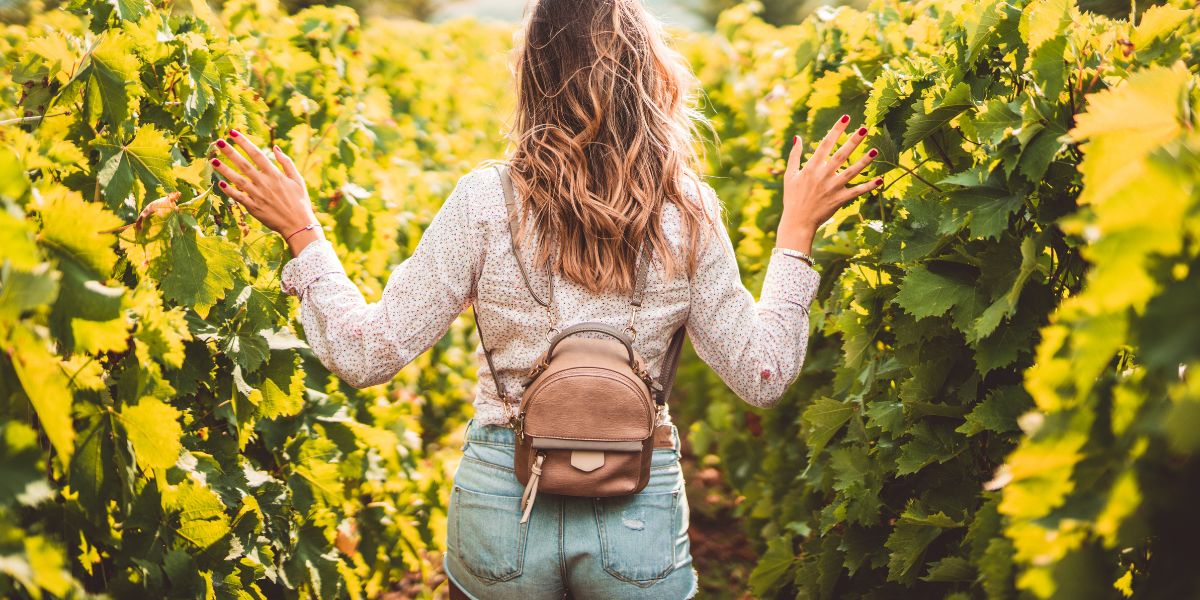 Girl walking through a vineyard in the US
