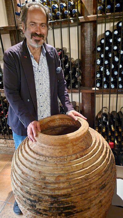 Winemaker Panayiotis Papagiannopoulos with ceramic vat