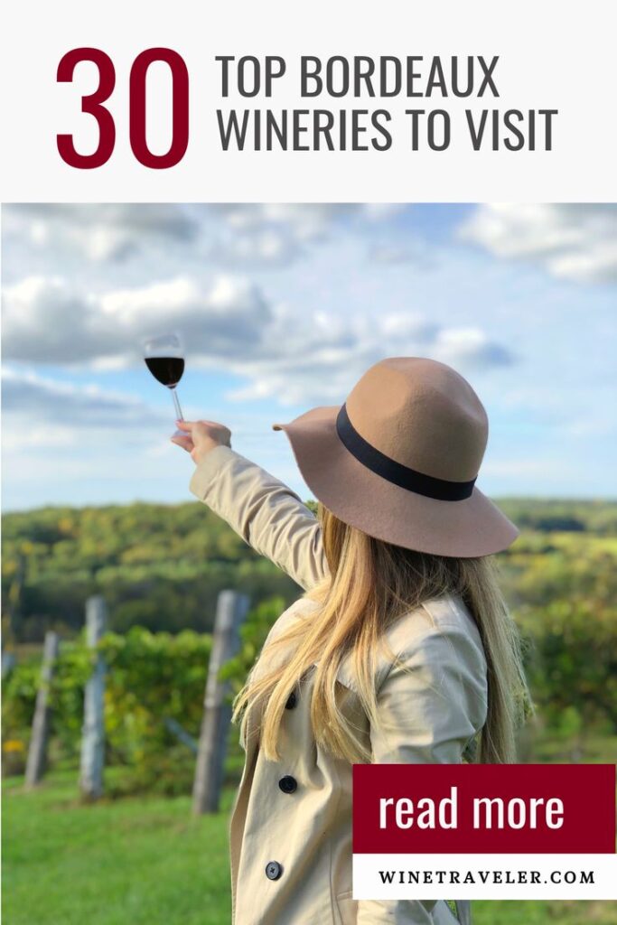 Winetraveler holding a glass of wine at a vineyard in Bordeaux