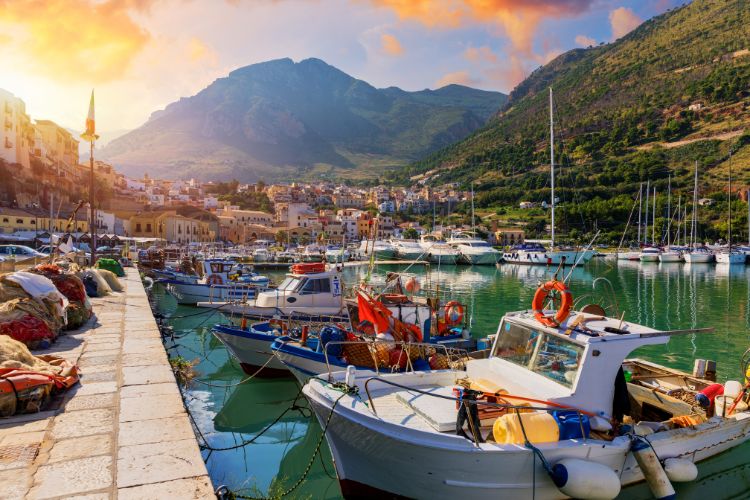 Castellammare del Golfo view with fishing boats and mountains in the background